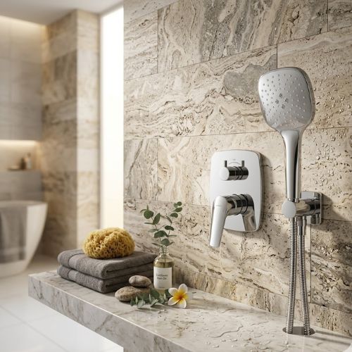 Sleek chrome concealed shower mixer with square handheld spray on textured stone wall.