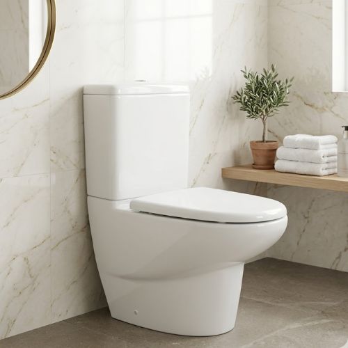 Modern close-coupled toilet with a streamlined porcelain base and slimline cistern, displayed in a contemporary marble-tiled bathroom interior.