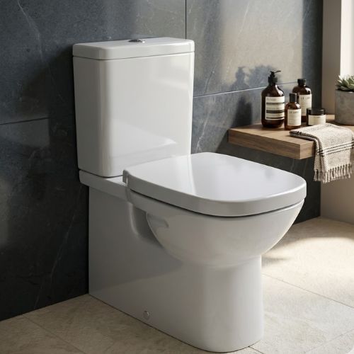 A professional, close-up shot of the Debra Square Horizontal WC, featuring a sleek white ceramic design with a soft-close lid, set against a modern charcoal marble wall.