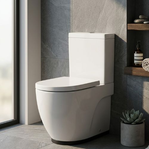 Sleek Meridian Floor Standing WC in white ceramic, featuring a modern soft-square design against a luxury stone-tile background.