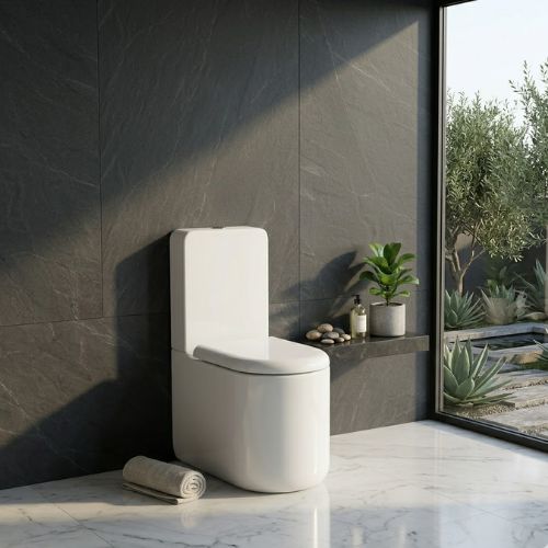 Modern Status WC in white ceramic, featuring a sleek skirted design against a luxury slate-tiled background.