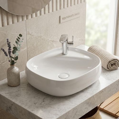 Modern white over-countertop washbasin with a chrome faucet set on a marble vanity in a luxury bathroom.