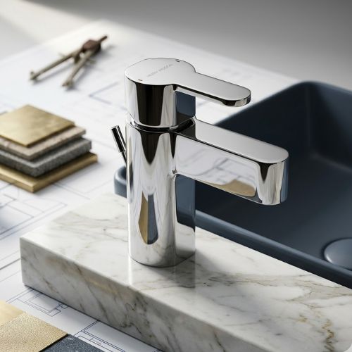 Polished chrome mono basin mixer tap with a modern geometric design, displayed on a marble surface with architectural blueprints.