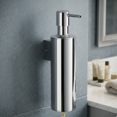 Sleek wall-mounted chrome metal soap dispenser with a modern cylindrical design and precision pump, professionally installed in a luxury bathroom setting.