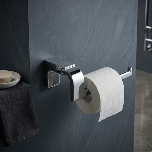 Modern chrome ELETECH open rollholder mounted on a dark textured stone wall, showcasing sleek architectural design for luxury bathrooms in Nigeria.
