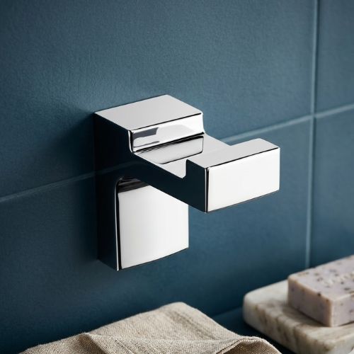 Polished ELETECH chrome robe hook featuring a bold, minimalist schematic design, securely wall-mounted in a luxury bathroom setting for high-end Nigerian interiors