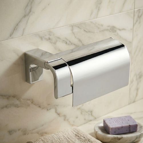 Premium ELETECH chrome toilet roll holder with a sleek protective cover, wall-mounted against a luxury marble background to showcase executive washroom elegance for the Nigerian market.