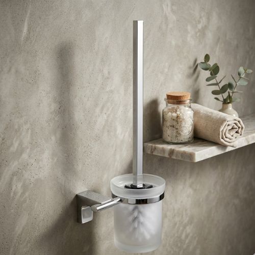 Wall-mounted ELETECH luxury toilet brush with a polished chrome handle and frosted glass holder, set against a modern stone-textured bathroom wall.