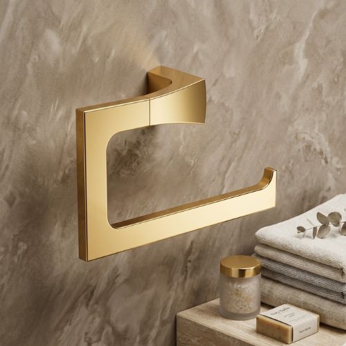 A high-end polished gold open towel ring mounted on a luxury marble wall, styled alongside plush towels and premium bath accessories.
