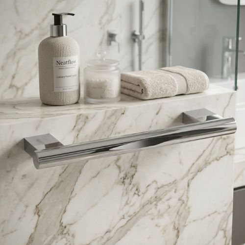 A sleek, 30mm professional-grade chrome grab bar mounted on a luxury marble wall, accented with a Neatflow designer soap dispenser and plush hand towels.