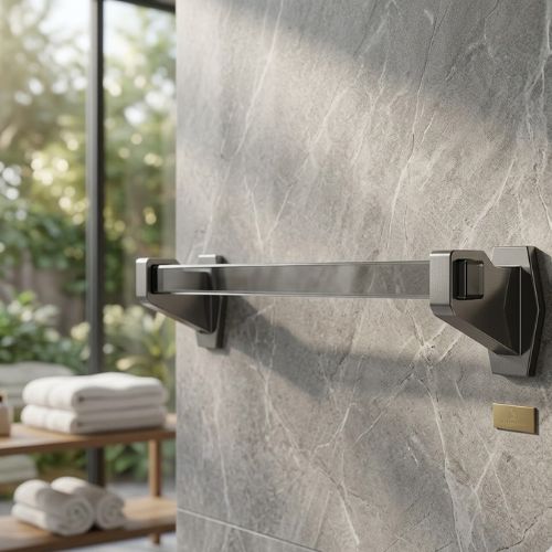 A professional, wall-mounted Luce Towel Bar featuring a bold square-profile rail in a matte graphite finish, set against a luxurious grey stone tile wall.