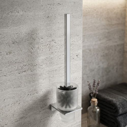 A modern S-Cube wall-mounted WC brush set with a frosted glass holder and polished chrome square handle, displayed against a luxury stone bathroom wall.