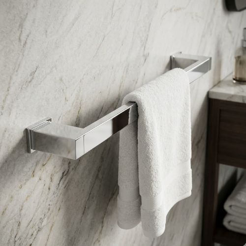 A luxurious, wall-mounted S-Cube chrome towel bar featuring a polished mirror finish, styled with a plush white towel in a high-end marble bathroom setting with a dark wood vanity.