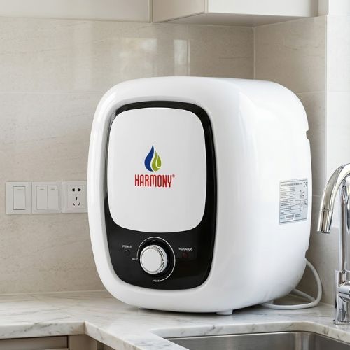 A sleek, modern 10-liter Harmony electric water heater installed in a contemporary kitchen, highlighting its compact design and premium white finish.