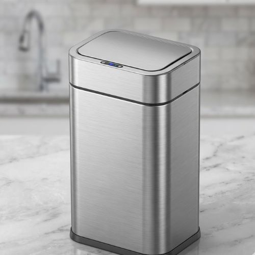 A high-capacity stainless steel smart sensor bin with a touchless lid, set against a modern, blurred kitchen background.
