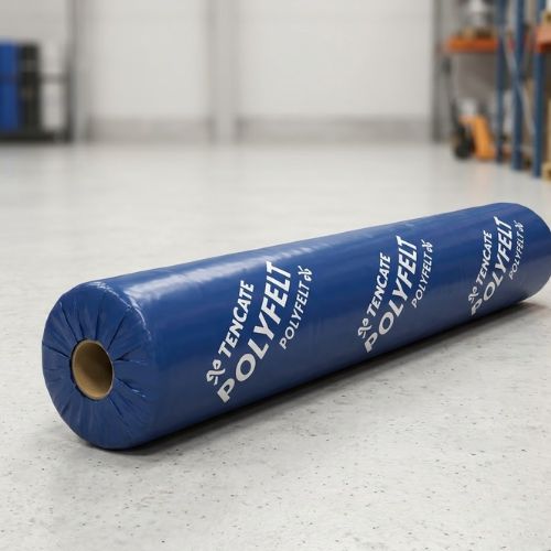 A professional roll of TenCate Polyfelt geotextile fabric membrane (4.5m x 100m) displayed in a bright, modern warehouse setting.
