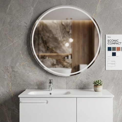 A minimalist white bathroom vanity with an integrated sink and large circular mirror, displayed in a modern, elegant showroom setting.