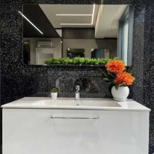 A premium white wall-hung bathroom vanity set with a sleek integrated sink and a rectangular mirror, displayed in a clean, high-gloss finish.