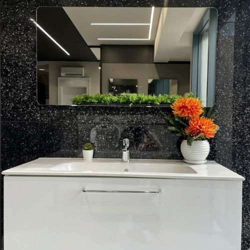 A premium white wall-hung bathroom vanity set with a sleek integrated sink and a rectangular mirror, displayed in a clean, high-gloss finish.