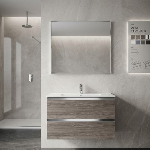 A modern, wall-mounted Vida Compact 80 bathroom vanity featuring a rich wood-grain finish, sleek integrated basin, and matching mirror, set in an elegant, contemporary bathroom space.