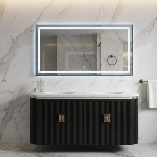 A luxurious, wall-mounted double vanity with dark fluted cabinetry and a white marble countertop, featuring dual vessel sinks, a large rectangular LED-lit mirror, and elegant marble wall and floor tiles in a modern bathroom setting.