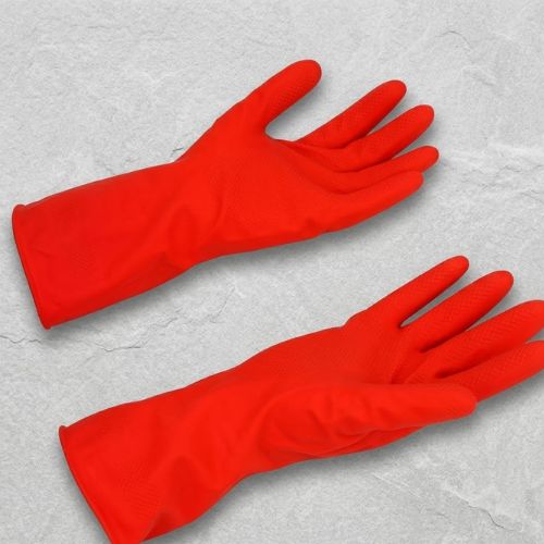 A pair of industrial red rubber safety gloves against a neutral stone-textured background.