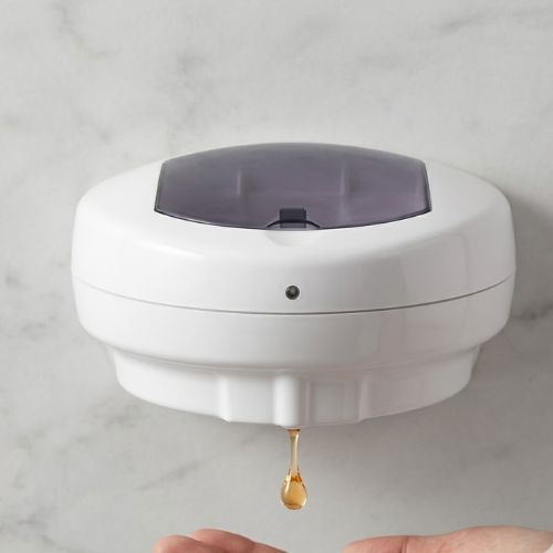 A wall-mounted 700ml automatic soap dispenser dispensing a drop of liquid into a hand against a marble-style background.